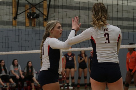 Kaitlin Meyer slaps the hand of teammate Nora Troppmann during American River College’s match against Cosumnes on Oct. 21, 2015. Meyer said Troppmann is "one of my best friends." (Photo by Nicholas Corey)