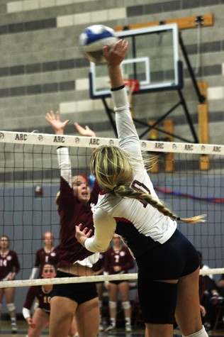 American River College offensive hitter Kaitlin Meyer swats the ball as a Sierra College defender rises to block. Sierra won the match by a score of 25-23, 25-21, 25-18, 25-20 on Nov. 13, 2015. (Photo by Nicholas Corey)