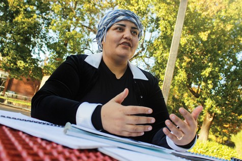 American River College student Mahjabeen Zazai sits with the lesson plans she used when she taught English in her native country of Afghanistan. Zazai said she has encountered some prejudice in America. (Photo by John Ferrannini)