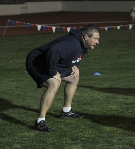Offensive coordinator Doug Grush instructs ARC's players during a drill on Feb. 23, 2016. Grush and all but head coach Jon Osterhout aren't paid to give instruction for the off-season conditioning class, which is a requirement in order to be on the football team in the fall. (Photo by Matthew Peirson)