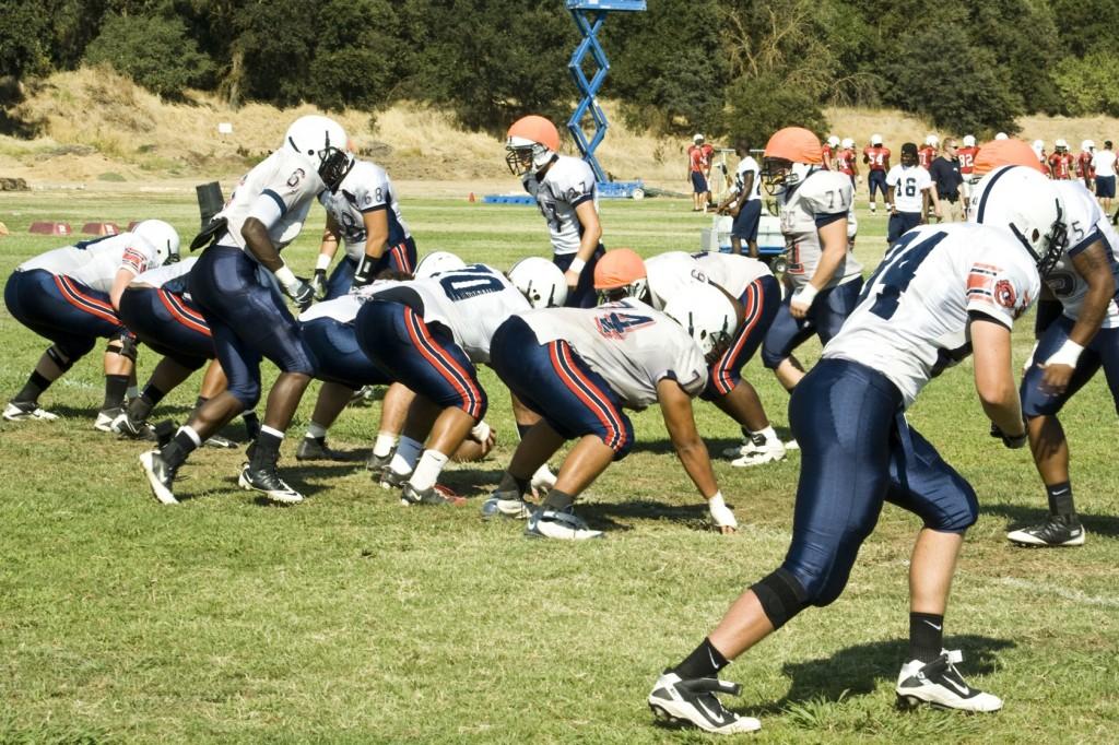 The ARC football running back squad practices on the American River College field. Photo by Bryce Fraser