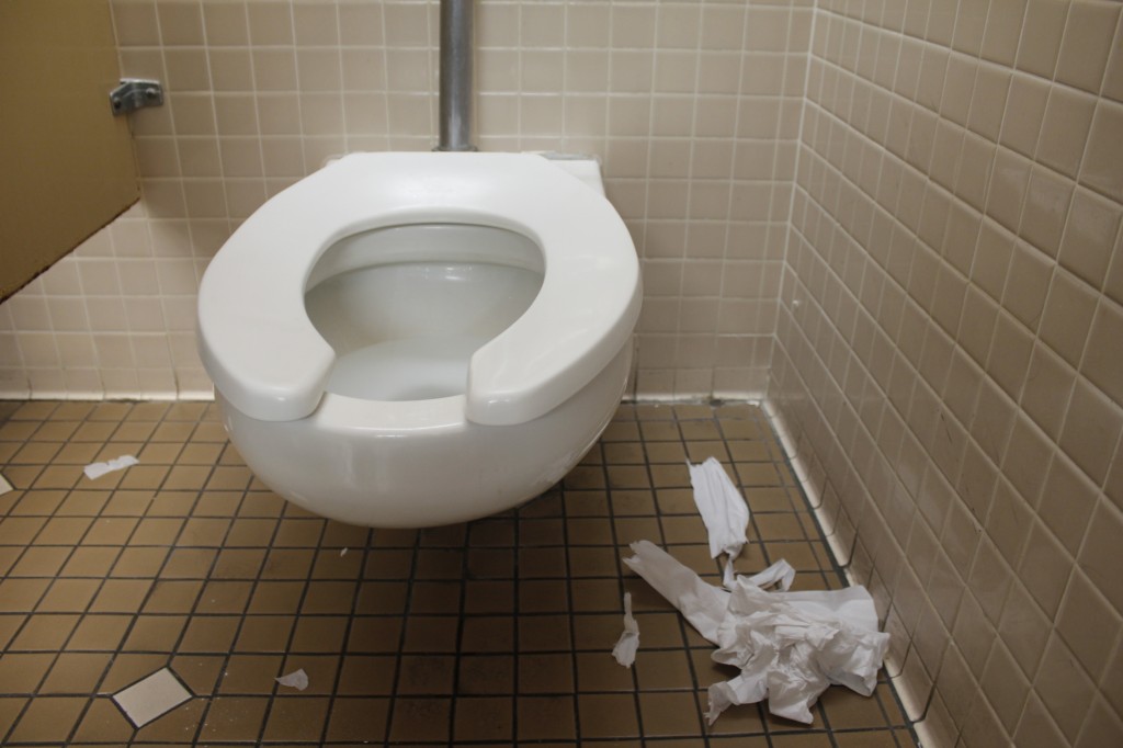 A shot of a toilet in the Student Services EOP&S restroom shows the trash on the floor. The womens bathrooms are just as dirty as the mens restrooms. (Photo by Shanel Royal)