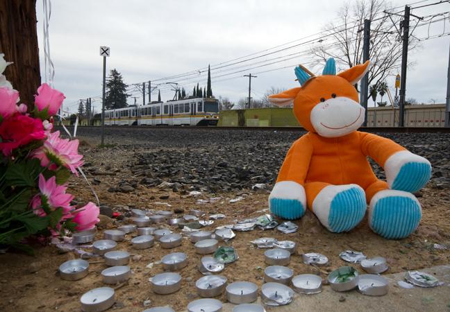 A vigil is set in place near the scene of the Jan. 28 light-rail accident that resulted in the death of two students. (Photo by Bryce Fraser)
