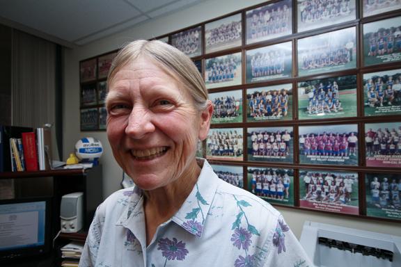 Dean of athletics Jean Snuggs, who is set to retire in June, stands in her office on April 9 ub front of numerous photos of athletes from over the years. (Photo by Bryce Fraser)