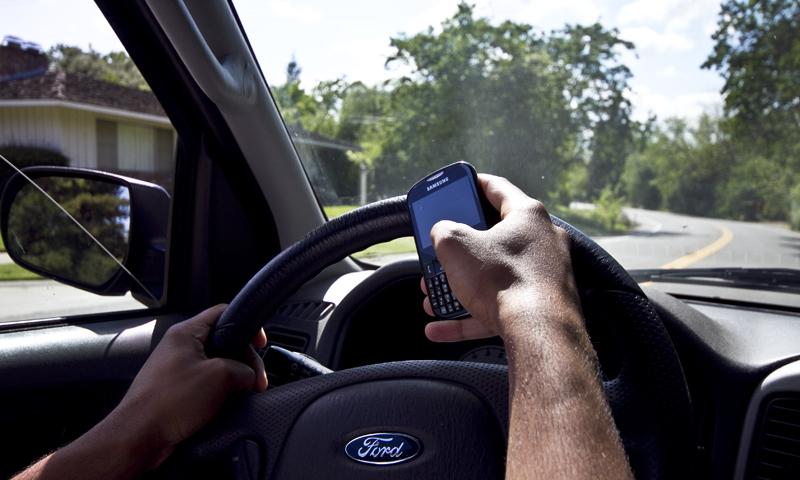 Campus police warn drivers of dangers of texting while behind the wheel, issue citations to offenders. (Photo Illustration by Daniel Romandia)