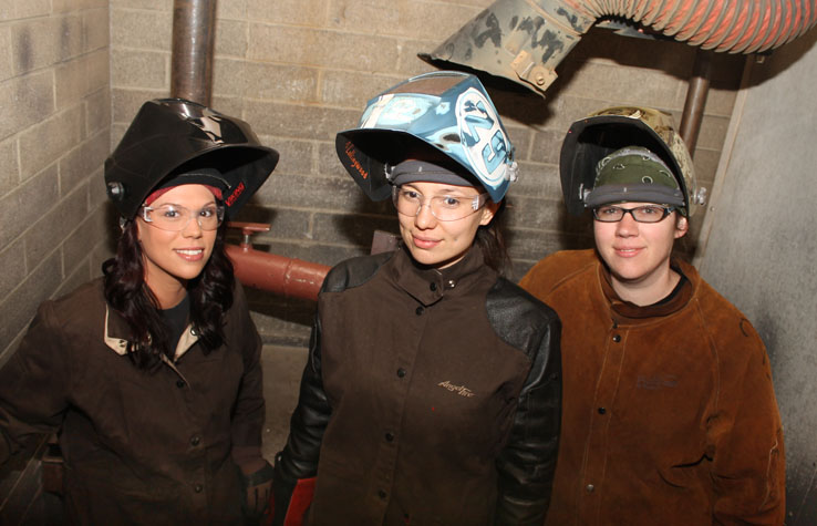 (From left to right) Melissa Scheetz, Katherine Collingwood and Sarah Spitzer pose in their welding gear in the lab on April 10, 2013.  Scheetz, Collingwood and Spitzer all competed in the SkillsUSA competition in San Diego on April 4-7. (Photo by Stephanie Lee)