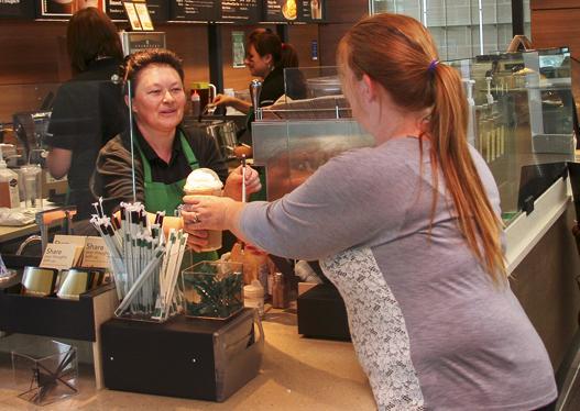 Barista serves up coffee and compliments