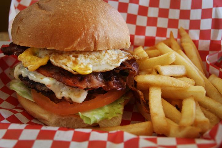 Burger Max constructs many different burgers including the Super Burger that is topped with your choice of cheese, two big slices of crisp bacon and a whole fried egg. (Photo by Emily K. Rabasto)