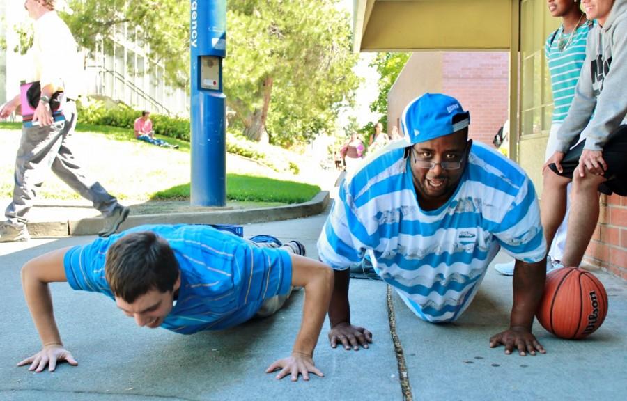 David Himojosa (left, Sport Science major) and Carter The President French (right, Diesel Mechanics major) jokingly challenge each other to a push up contest outside the liberal arts building near the Rose Marks Pavillion on Thursday, August 29. (Photo by Emily K. Rabasto)