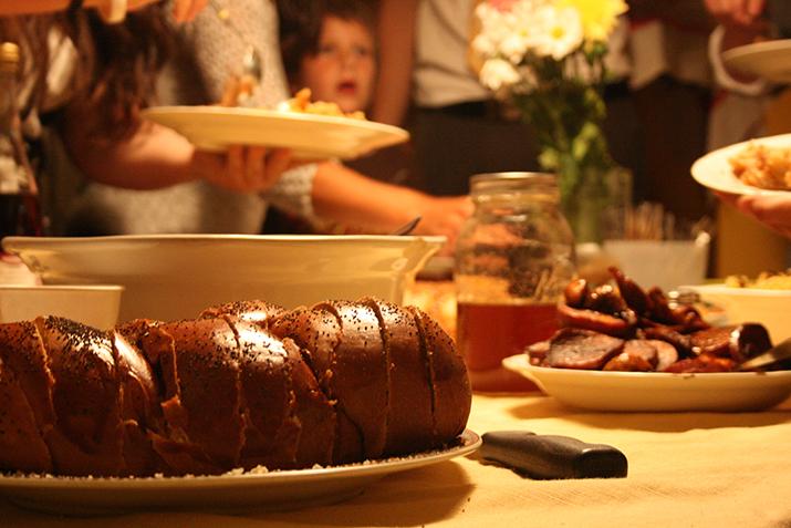 The Purves family and their guests dig into Challah (traditional egg bread), honey for dipping apples and sweet potatoes in balsamic vinegar during the Jewish holiday of Rosh Hashanah on Sept. 6.