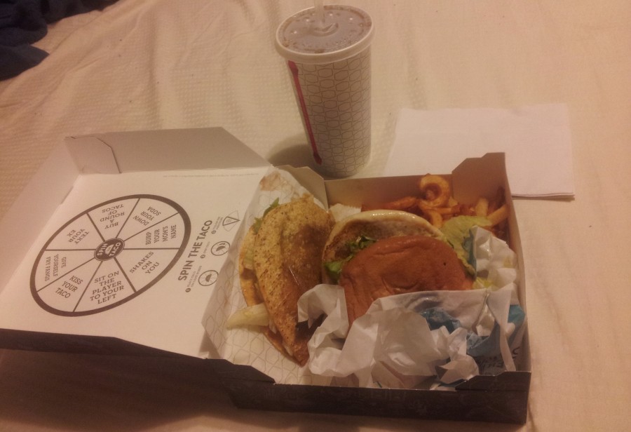 Jack’s Munchie Meal in its box with a greasy taco, fries, and a sandwich dripping with cheese.