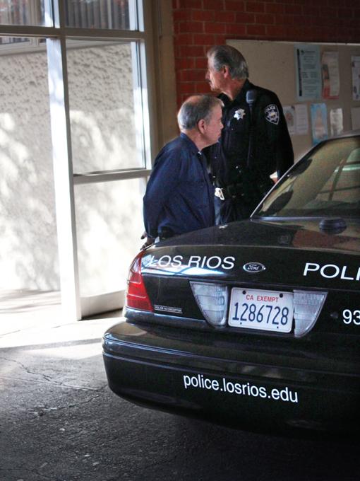 Officer Frank Smith arrests a man outside of Business 123 around 1 pm on Monday Nov. 25.