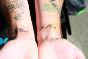 Business major Logan Pendelton shows his regret tattoos on his wrists.