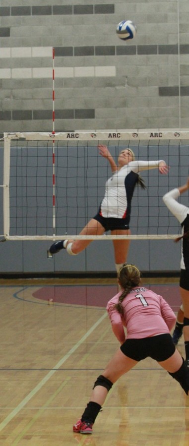 Sophomore middle hitter Nicole Hareland goes for a kill during the first round playoff match against Hartnell College. 