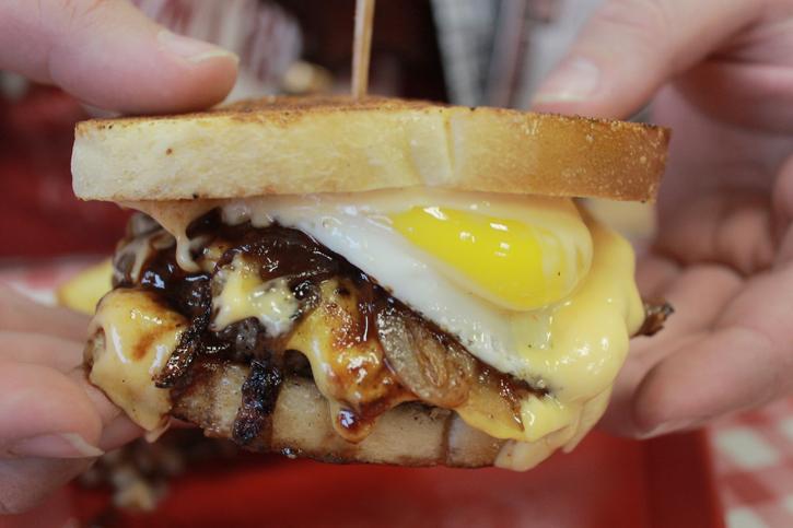 The Hot Mess burger is topped with roasted garlic aioli, house-made barbecue sauce, caramelized onions and a sunny side-up egg. Photo by Emily K. Rabasto