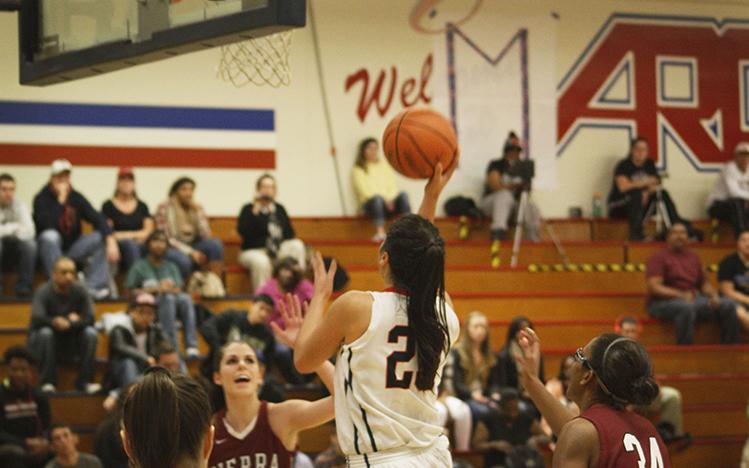 Sophomore guard Gloria Garcia goes for a layup in Friday nights game against the Sierra College Wolverines, the proceeds of which went to the Marc Zhuchenko memorial fund. 
