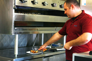 Armenian native “Andy” Andronik Muradyan removes chunks of fire-roasted chicken breast, the restaurant’s bestseller. Muradyan and his family have owned Royal Kebab for more than two years.