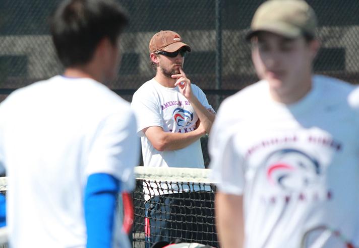 Coach Bobak Jabery-Madison watches his team play on Mar. 21. Jabery Madison won his second Coach of the Year award, and five of the mens tennis players made the Big-8 All Conference team. Photo by Emily K. Rabasto