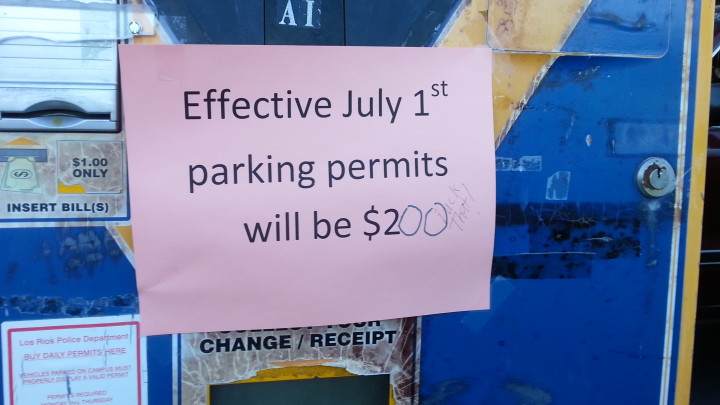 “Oh, look, a political statement,” said LRPD officer Kathy Church, in reference to a written comment on one of the many pay stations throughout the ARC campus she reset this morning as a result of the district-wide daily parking pass fee increase effective today. (Photo by Brooke Purves)