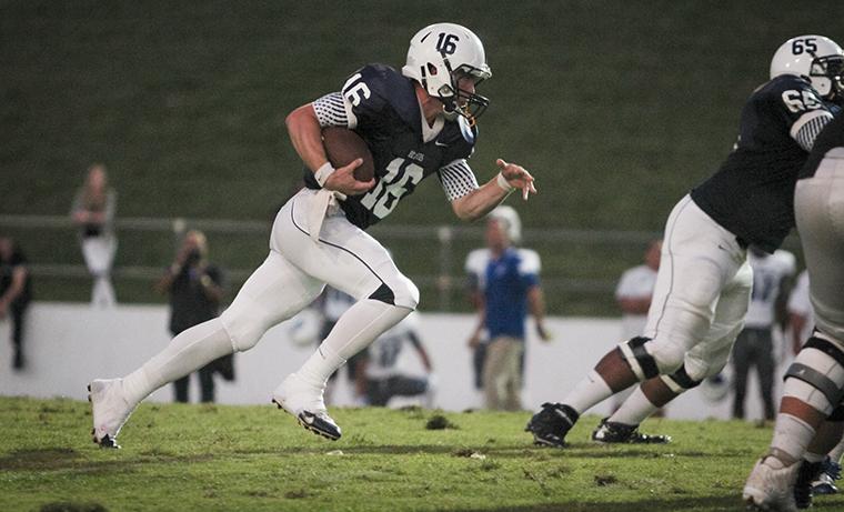 Backup quarterback Peyton Wilfley runs the ball through the College of San Mateo’s defensive line during the game against San Mateo Saturday Oct. 4.