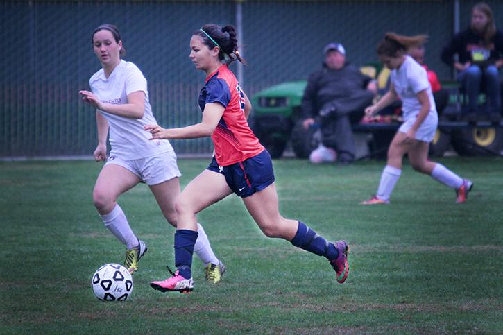 Sophomore mid-fielder Haley Halaran drives the ball down field during a match against Sacramento City College. Halaran eventually scored against SCC by hitting the ball into the goal with her head.