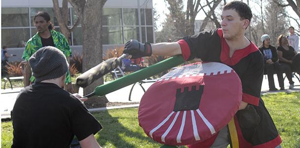 Amtgard club members go to war outside student center