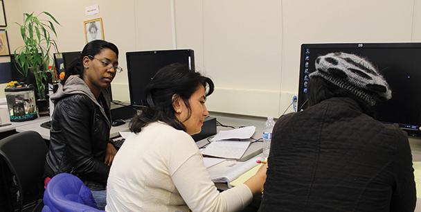 Suzette Brand(left), proctor in the DSP&S department looks on as Irina Li,(middle) Peer couch and also an ARC student volunteer, helping a student with her studies.  
