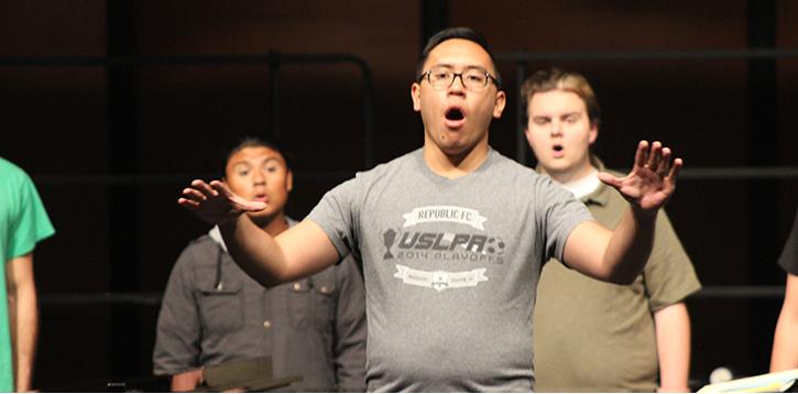 Tim Mascarinas, a Sacramento State student practicing at ARC, conducts the chamber choir at the rehearsal for their performance “It Gets Better”.