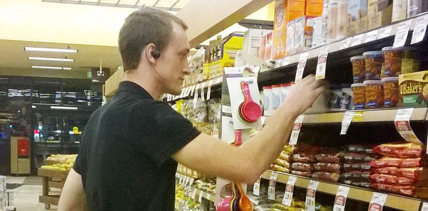 Raley’s employee Cody Drury stocks merchandise while on a shift as a courtesy clerk. Drury is a student at Sacramento State University and has been with the grocery store business for almost three years and he plans to stay with the company even after he receives his degree. 