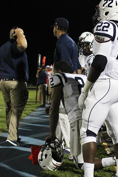 American River College quarterback Jihad Vercher, left, watches from the sidelines after being pulled in the third quarter. Vercher, a sophmore transfer from Sacramento State, had 259 passing yards with one touchdown and one interception. (Photo by Barbara Harvey)