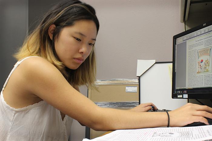 Student worker Emma Jaques designs an upcoming edition of The Parrot. The Parrot is a newsletter that is published on the American River College campus that showcases work by English as a second language students. (Photo by Lena DoBynes)