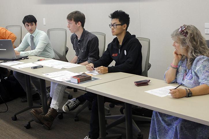 Student Senate President Garrett Kegel, left, Clubs and Events Board President Justin Nicholson, Sen. Kevin Phan and Sen. Laurie Jones discuss student concerns Thursday over the universal transit pass Measure A. Voting will take place Sept. 22-23 on eServices. (Photo by Jordan Schauberger)