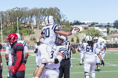 American River College's Steven Ponzo lifts Marc Ellis in celebration after scoring a touchdown against City College of San Francisco in San Francisco on Sept. 26. ARC won the game on a last second field goal 20-17.