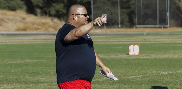 American River College Defensive Coordinator Lou Baiz points out a play downfield during practice on Wednesday, Sept. 2, 2015. Baiz comes from a family of coaches, including his father, who was a head coach for 35 years. (Photo by Joe Padilla)
