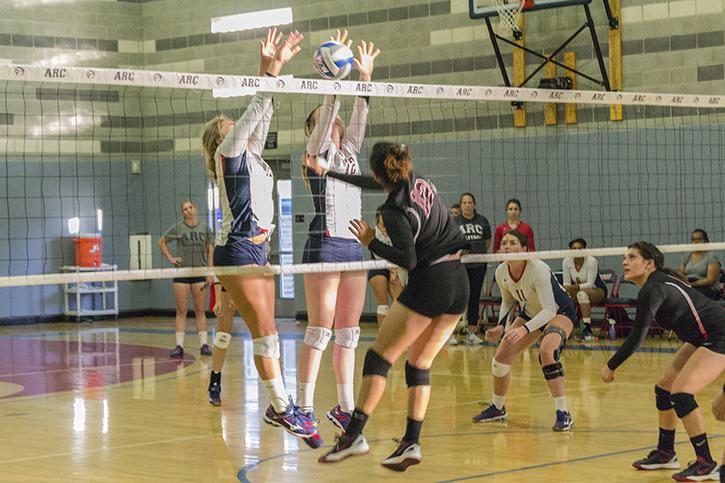 Erin Fogarty and Kaitlin Meyer go above the net for American River College to block a shot from Portervilles Ana Madrigal during the tournament match on Sept. 18, 2015. ARC won the match 25-9, 25-8, 25-13. (Photo by Joe Padilla)