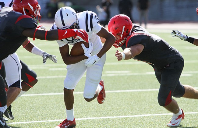 City College of San Francisco defensive back Vince Camp and linebacker Khalil Hodge attempt to bring down American River College wide receiver Damen Wheeler during ARC’s 20-17 win over City College of San Francisco on Sept. 26, 2015. ARC’s offense had 389 total yards. (Photo by Barbara Harvey)