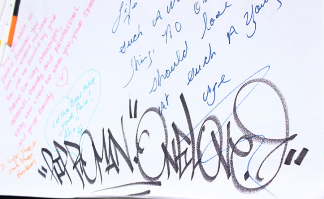 A tag reads “RIP Roman Gonzalez” on a condolences poster at the love-in at Sacramento City College on Sept. 4, the day after a fatal shooting at the campus left one man dead and two injured. Hundreds filled the college’s Quad for the love-in event and an information session, during which Los Rios District Chancellor Brian King addressed attendees and answered questions. (Photo by Barbara Harvey)
