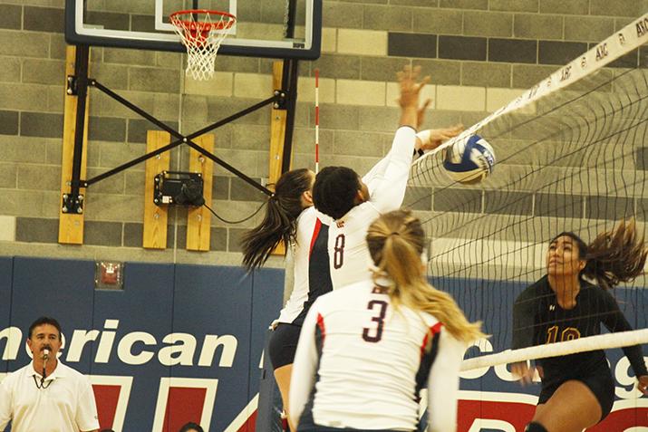 Sophomore middle blocker Erianna Williams, middle, and freshman outside hitter Candice Reynoso, left of Williams, block a spike attempt by Hartnell sophomore Neysha Laumatia. ARC won 3-2 and also won their second match of the doubleheader against Hartnell College on Aug 28, 2015. (photo by Kameron Schmid)