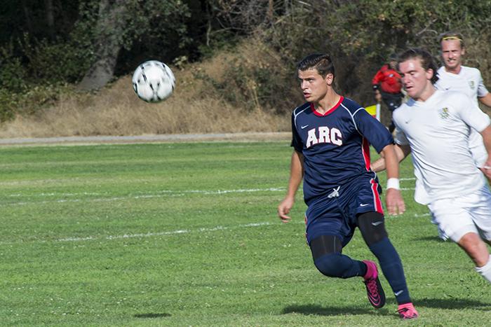 American River College forward Hector Zavala, left, moves the ball downfield during ARCs 1-0 loss to Feather River College on Aug. 28, 2015. FRC scored the only goal of the game early in the first half. (Photo by Joe Padilla)