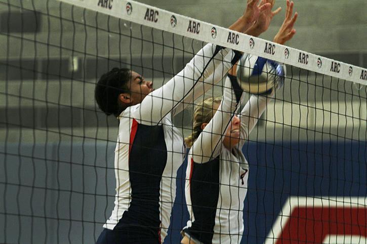 Erianna Williams and Nicole Suther, middle blockers for ARC, attempt to block a shot from Cabrillo. ARC lost three sets to two, winning two sets in a row to take the match to a fifth. (Photo by Nicholas Corey)