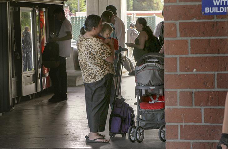 A woman holding a toddler outside of Davies Hall on American River College Campus. There is a daycare facility available in the child development center to assist parents who attend ARC and have no other way for their children to be watched. (Photo by Mychael Jones)