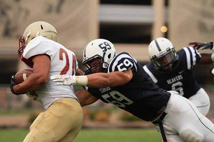 American River College line backer Jordan Kunaszyk tackles De Anza running back Trevon Harris during ARC’s 38-2 win over De Anza on Saturday, Sept. 12, 2015. ARC’s defense shut out De Anza offense, holding them to just 42 total rushing yards. (Photo by Barbara Harvey)