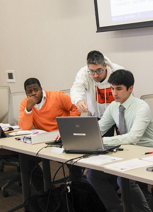 Former Vice President Sam Kinsey, left, then-Sen. David Hylton, center, and former President Garrett Kegel discuss the wording of a bill to be voted on during the Student Senate meeting on Sept. 17th. Student safety on campus has been a major topic of discussion during the Student Senate meetings.  
(Photo by Jordan Schauberger)