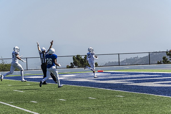 American River College safety Robert Sanders picks up a fumble and runs into the end zone for a touchdown against College of San Mateo at San Mateo Oct. 3, 2015. CSM won the game 42-10. (photo by Joe Padilla)