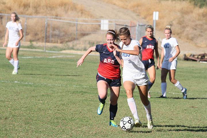 Modesto Junior College forward Jenna Viss (22) steals the ball from ARC defensive player Kristen Grattan (5) during ARCs 2-0 win over MJC on Oct 2, 2015. ARCs record advanced to 5-3 with the win. (photo by Matthew Wilke)