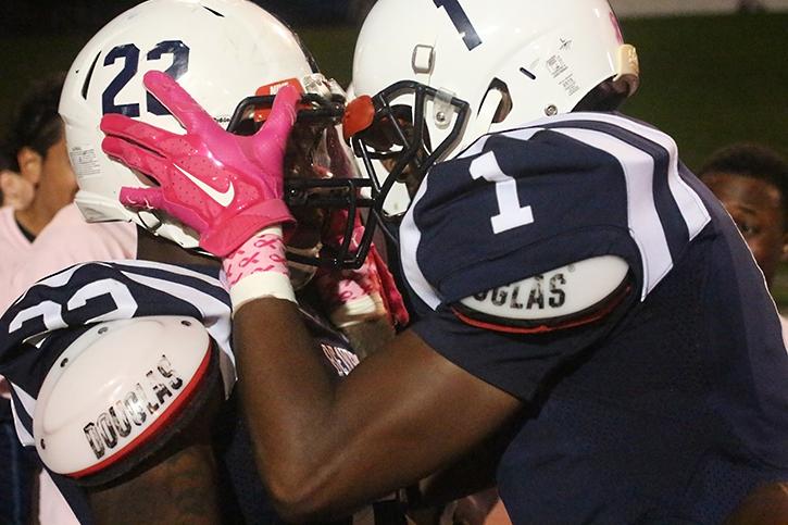 American River College wide receiver Khalil Hudson grabs running back Ce’von Mitchell-Ford by the helmet in celebration after Mitchell-Ford’s 33-yard touchdown run on Saturday, Oct. 17, 2015. (Photo by Barbara Harvey)