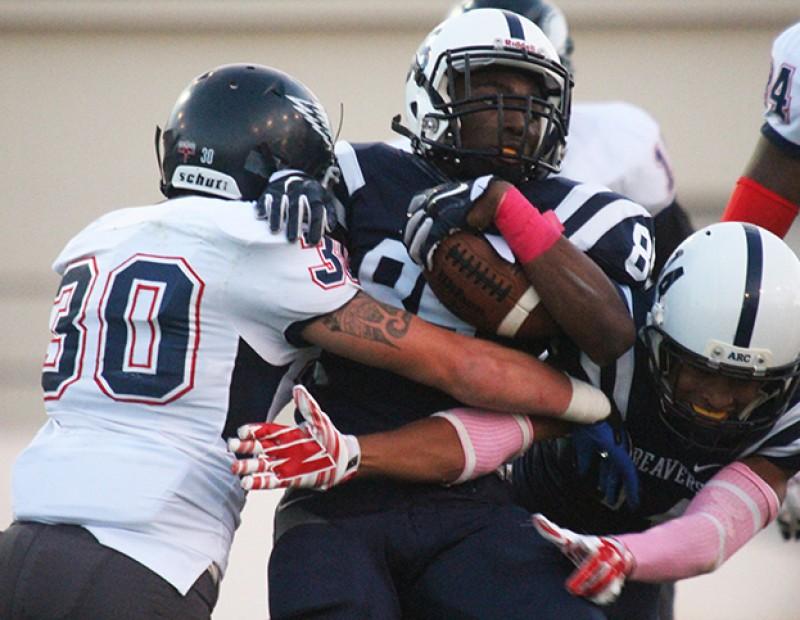 American River College wide receiver Torian Williams is brought down by College of the Siskiyous line backer Max Valdez while ARC wide receiver Daliceo Calloway misses the block during ARC’s 49-31 victory over COS on Saturday, Oct. 17, 2015. ARC dominated offensively in the first half, extending their lead to as much as 30 points at the end of the second quarter. (Photo by Barbara Harvey)
