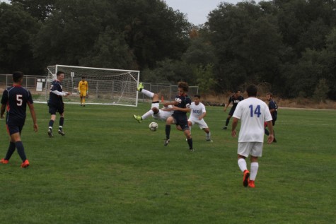 American River College midfielder Alex Rizzo, right, flips over Modesto Junior College midfielder Christopher Torres on Oct. 27, 2015. ARC defeated MJC 1-0 to advance its overall record to 5-10-3 on the season. (photo by Kevin Sheridan)
