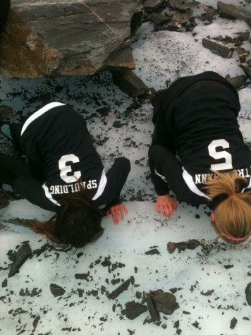 American River College volleyball outside hitter Nora Troppmann, right, and her teammate, left, drink glacier water during a team hike on their way to a tournament in Valdez, Alaska. Troppmann is now a freshman outside hitter for American River College's voleyball team. (Photo courtesy of Nora Troppmann)