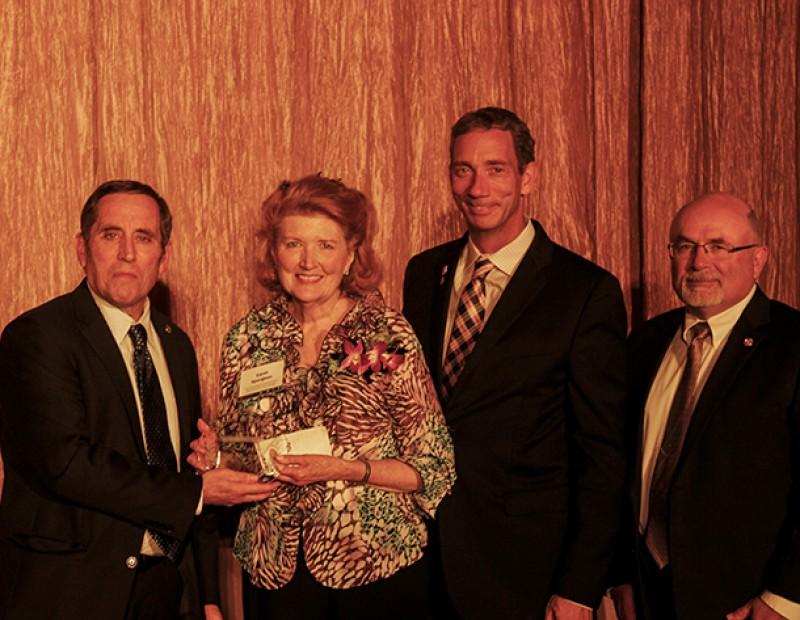 From left to right, Marty Katz, the Los Rios Foundation event chair, Carol Spurgeon, a donor to the Los Rios Foundation honored by Sacramento City College, Brian King, chancellor of the Los Rios Community College District, and Dave Younger, the chair of the Los Rios Foundation, pose for photographs on the stage of the Sheraton Grand ballroom in Sacramento on Friday during the Los Rios Foundation Honors and Awards Gala. Spurgeon is the mother of American River College professor Michael Spurgeon and was one of six donors honored at Friday’s event. (Photo by John Ferrannini)